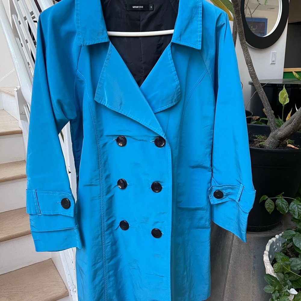 Stylish trench coat like top , material is shiny polyester like material .
